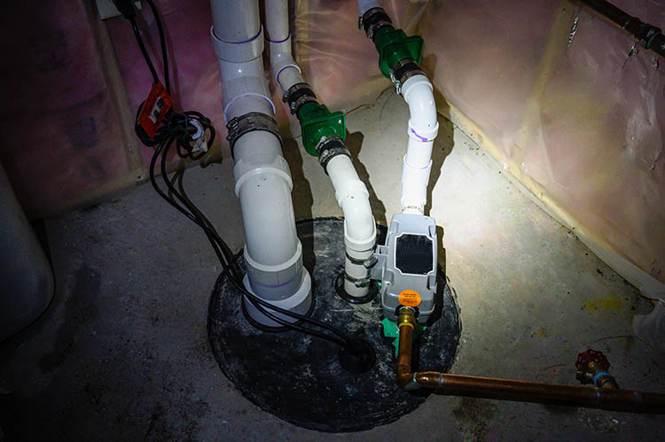 sump pump manhole with water backup viewed with a flashlight - Springfield IL